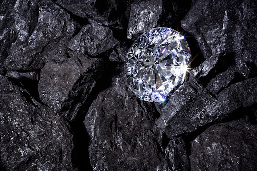 diamond nestled in pile of coal