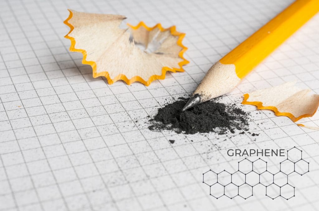 pencil and graphite powder laying on graph paper